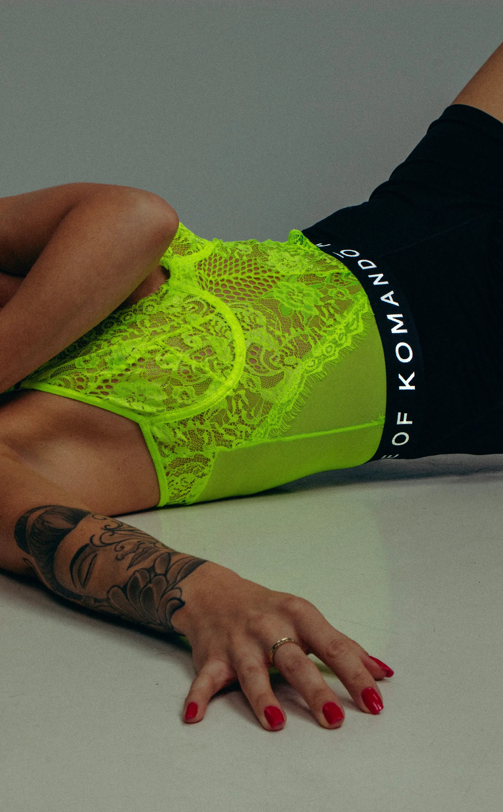 woman wearing a bright green lace top with foxerz from la maison komando